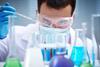 Male scientist examining test tubes