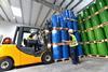 A picture showing a group of workers with forklift