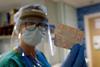 An image showing a nurse holding a pack of drugs