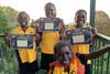 An image showing a group of children holding diplomas