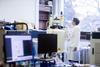 A Chemist using an NMR spectrometer in a lab