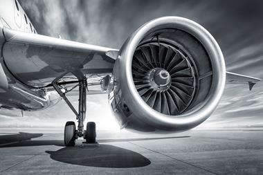 Black and white image showing a jey engine and plane wing