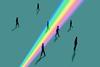 An image showing silhouetted people stepping in and out of a beam of rainbow