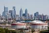 An oil refinery with a city in the background