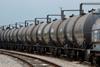 A line of oil rail tankers on a track