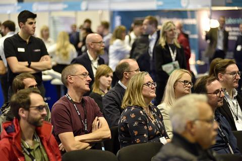 Audience members seated at the Lab Innovations conference listening to a talk