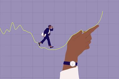 Woman in business attire walking up a graph sustained by a hand